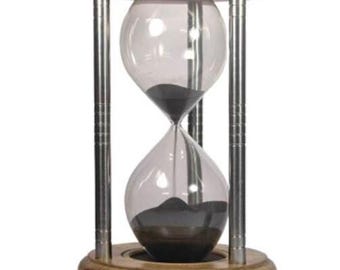 May include: A wooden hourglass with a silver metal frame and black sand. The hourglass is on a white background.