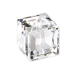 May include: A clear crystal cube bead with a hole through the centre. The bead is faceted and has a shiny finish.