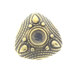 May include: Gold-toned triangular pendant with a circular design in the center and intricate details around the edges.
