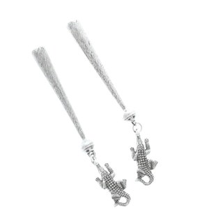 May include: A pair of silver earrings with a dangling alligator charm. The earrings are long and slender, with a textured surface.