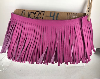 May include: Pink leather fringe trim with a brown tag that says "C1027-41 14ft".