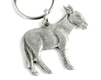 May include: A silver donkey keychain with a split ring. The donkey is standing on all four legs with its head turned to the side.