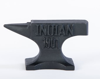 May include: Black cast iron anvil with the words "INDIAN 1901" embossed on the top.
