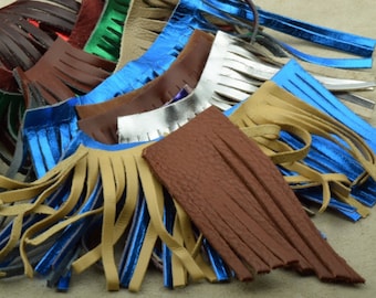 May include: Assortment of leather fringe trim in various colors, including brown, tan, blue, and silver. The fringe is made of thin strips of leather that are sewn together to create a decorative edge.