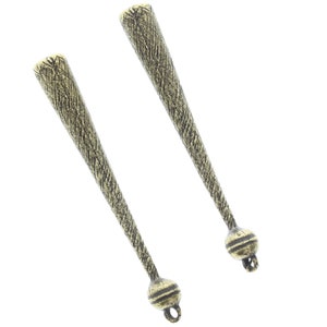 May include: Two gold-toned metal decorative finials with a textured surface and a round ball at the end. Each finial has a small loop at the bottom.