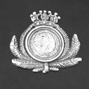 May include: Silver-toned metal badge with a circular design. The badge features a crown with five points and a wreath of leaves surrounding a blank circular space.
