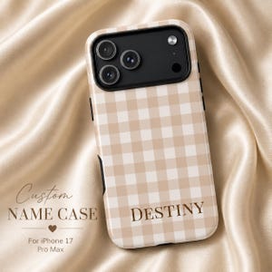 May include: A phone case for iPhone 17 Pro Max with a tan and white gingham design. The case is personalised with the name "DESTINY". The words "Custom Name Case" are also displayed.