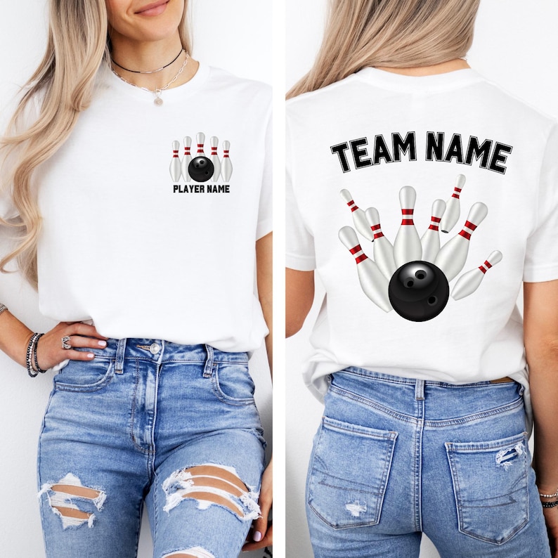 May include: White t-shirt featuring a bowling design. The front displays a bowling ball and pins with "PLAYER NAME" text. The back shows a bowling ball and pins with "TEAM NAME" text. The shirt is paired with blue jeans.