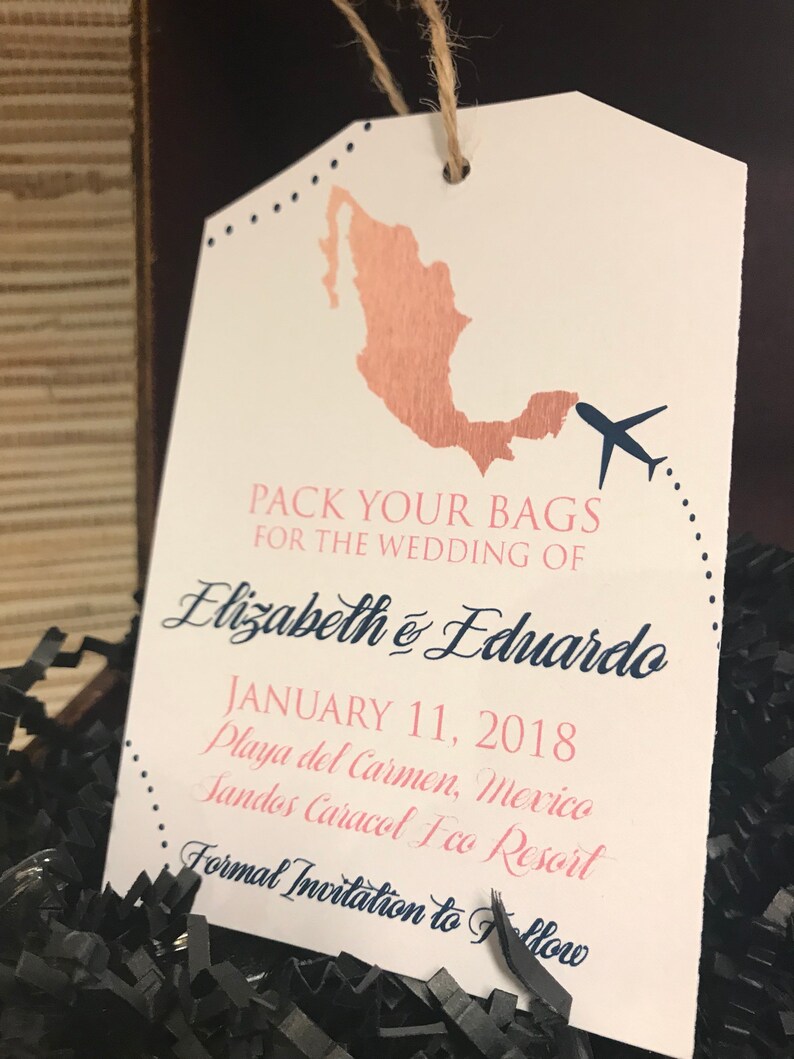 May include: A white luggage tag with a brown outline of Mexico, a blue airplane, and the text "Pack your bags for the wedding of Elizabeth & Eduardo January 11, 2018 Playa del Carmen, Mexico Sandos Caracol Eco Resort Formal Invitation to Follow"