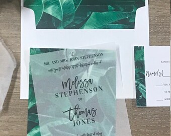 May include: A wedding invitation with a tropical theme. The invitation is printed on clear vellum paper with a green leafy pattern. The text reads "Mr. and Mrs. John Stephenson request the pleasure of your company at the wedding of Melissa Stephenson to Thomas Jones Saturday the first of May Two Thousand Nineteen at five o'clock in the evening Rick's Cafe and Bar Montego Bay, Jamaica"