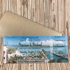 May include: A blue and white save the date announcement in the form of a boarding pass. The announcement says "Get your passports ready! Save the Date Marissa & Michael Are Getting Married! Saturday, December 3, 2016 Turks and Caicos For additional wedding details, please visit: theknot.com/us/marissaandmichael2016". The boarding pass also has a date of December 03, 2016.