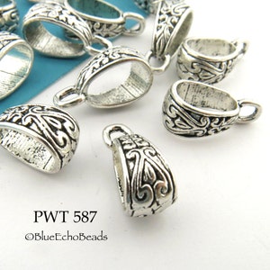 May include: Silver-toned metal pendant bails with an ornate floral design. The bails are oval-shaped with a loop at the top for attaching a pendant. PWT 587 ©BlueEchoBeads