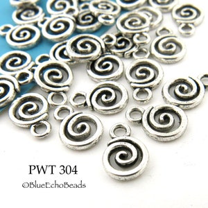 May include: A close-up of a group of silver-toned metal charms shaped like a spiral. The charms have a loop at the top for attaching to jewelry or other crafts.