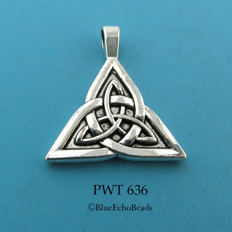 May include: Silver Celtic knot pendant in the shape of a triangle. The knot is intricate and detailed. The pendant has a loop at the top for hanging.