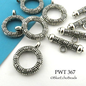 May include: Silver tone metal toggle clasps with a woven design. The clasps are in the shape of a circle and a bar. PWT 367 ©BlueEchoBeads