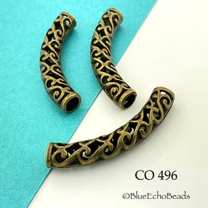 May include: Three antique gold metal decorative bead caps with a filigree design. The bead caps are shaped like a half-circle.  CO 496 ©BlueEchoBeads