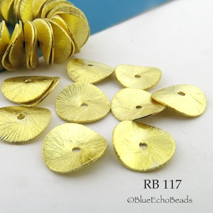 May include: Gold-toned metal sequins with a textured surface and a hole in the center. The sequins are shaped like a slightly rounded triangle.  RB 117 ©BlueEchoBeads