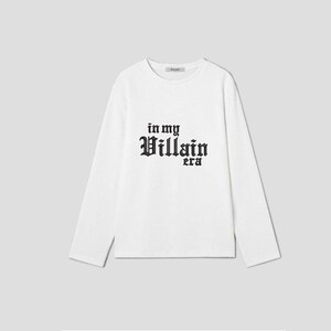 May include: White long-sleeve t-shirt with black text that reads "in my Villain era".