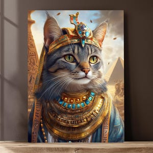 May include: A gray tabby cat wearing a gold and blue crown and necklace, with a background of a desert landscape and pyramids.