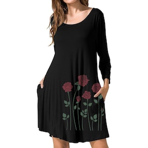 May include: Black casual dress with a scoop neck and 3/4 sleeves. The dress has a floral print of red roses with green stems and leaves on the bottom half of the dress.
