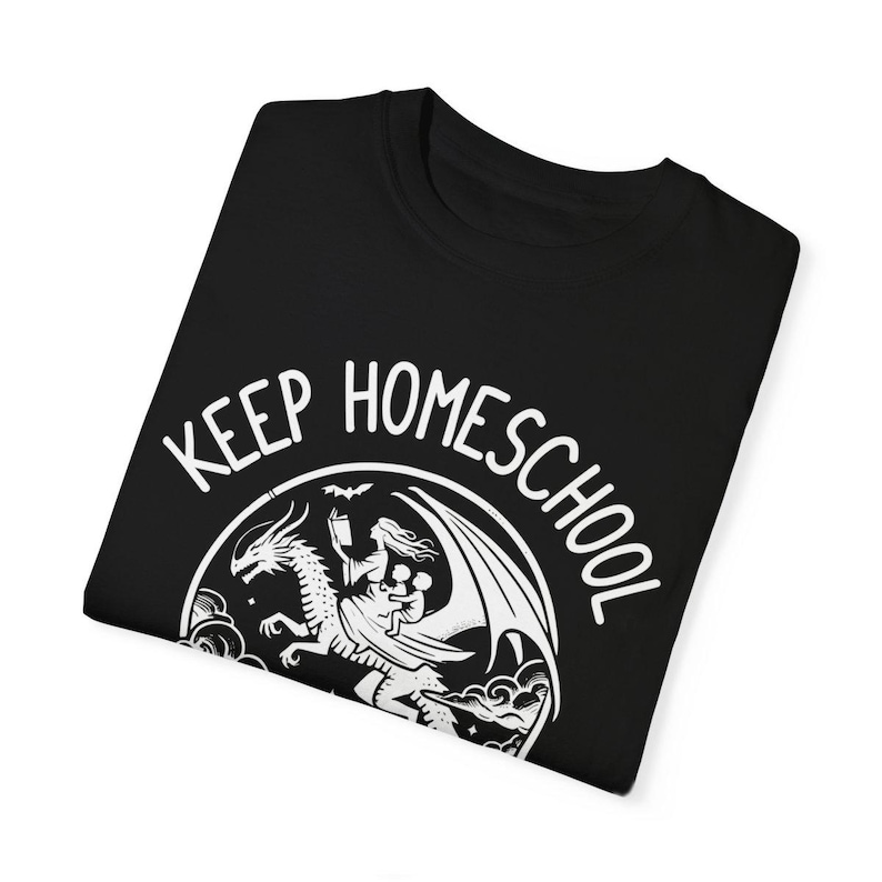 May include: Black t-shirt with a white graphic of a woman riding a dragon with the text "Keep Homeschool" around the graphic.