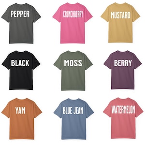 May include: Nine different colored t-shirts with white text on the back. The text on the shirts reads: Pepper, Crunchberry, Mustard, Black, Moss, Berry, Yam, Blue Jean, Watermelon.
