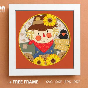 May include: A framed autumn-themed paper art piece featuring a scarecrow with a sunflower, holding a sign that says "HELLO FALL". The artwork is in a white frame and includes the text "+ FREE FRAME" and "SVG • DXF • EPS • PDF".