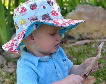 Organic boy's sun hat with wide brim, scooters and foxes, turquoise and green, reversible