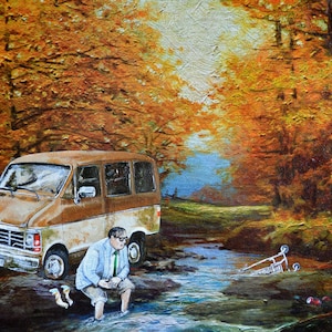 May include: A brown van parked in a forest setting with a man in a blue shirt and tie standing in a stream. The stream is surrounded by trees with orange and yellow leaves. A shopping cart is lying on its side in the stream.