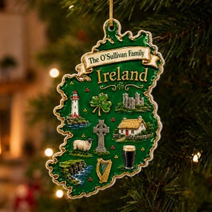 May include: A green, map-shaped Christmas ornament of Ireland featuring a gold banner with the text The O'Sullivan Family and Ireland. The ornament displays raised illustrations of a lighthouse, shamrock, castle, Celtic cross, sheep, cottage, harp, and a glass of stout.