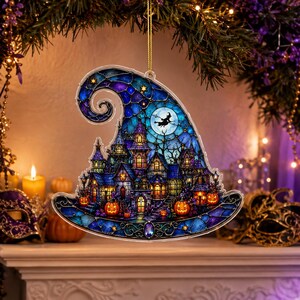 May include: A witch hat-shaped ornament featuring a stained glass-style illustration of a haunted house at night. The design includes a full moon with a flying witch silhouette, glowing orange pumpkins, and deep blue and purple architectural details.
