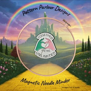 May include: A magnetic needle minder featuring a white heart shape formed by two hands, one green and one pink, with the text TOGETHER WE'RE UNLIMITED. The minder is centred within a wooden embroidery hoop against a background of a yellow brick road.