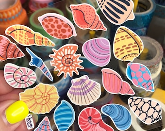 May include: A sheet of colorful seashell stickers with a variety of shapes, sizes, and patterns. The stickers are perfect for adding a touch of whimsy to journals, planners, and other craft projects.