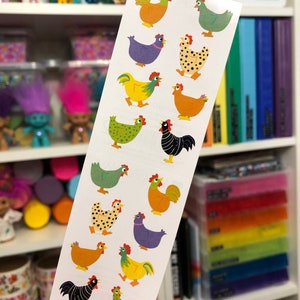 May include: A sheet of colorful chicken stickers. The stickers feature various breeds of chickens in different colors and patterns, including black and white, green, yellow, orange, and purple.