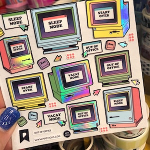 May include: A sheet of colorful holographic stickers featuring retro computer screen designs with text like "Sleep Mode", "Vacay Mode", and "Start Over".