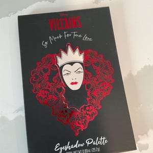 May include: Black eyeshadow palette featuring a red Evil Queen design with the text "VILLAINS So Much For True Love." The palette includes the text "Eyeshadow Palette" and "TOTAL NET WT. 0.89 oz. (25.2g)."