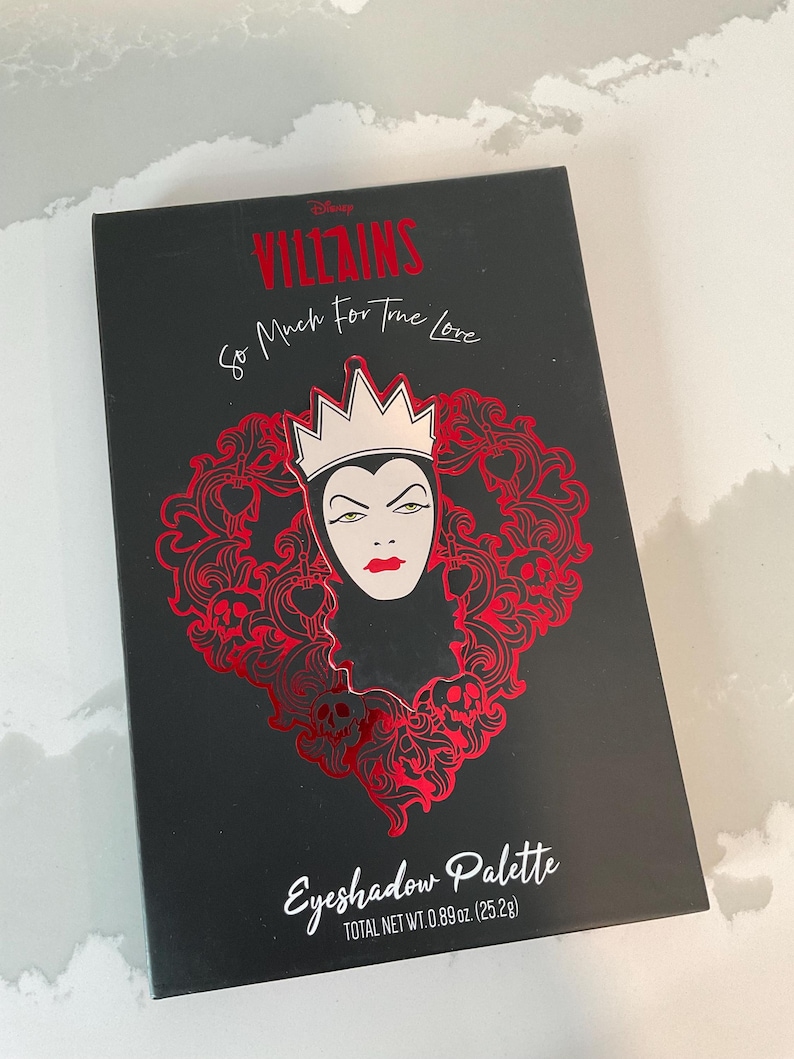 May include: Black eyeshadow palette featuring a red Evil Queen design with the text "VILLAINS So Much For True Love." The palette includes the text "Eyeshadow Palette" and "TOTAL NET WT. 0.89 oz. (25.2g)."