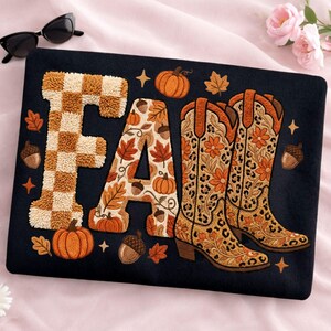 K&ouml;nnte beinhalten: Schwarzes Kissen mit dem Wort "FALL" in einem Herbstthema. Der Buchstabe "F" hat ein braun-beiges Karomuster. Der Buchstabe "A" ist mit Herbstbl&auml;ttern und K&uuml;rbissen verziert. Das "LL" ist ein Paar Cowboy-Stiefel.