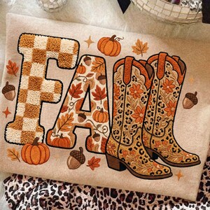 K&ouml;nnte beinhalten: Beige Grafik mit dem Wort "FALL" im Herbstthema. Der Buchstabe "F" hat ein braun-wei&szlig;es Karomuster. Der Buchstabe "A" ist mit Herbstbl&auml;ttern, K&uuml;rbissen und Eicheln verziert. Die Buchstaben "LL" sind Cowboy-Stiefel mit Blumen- und Leopardenmuster.