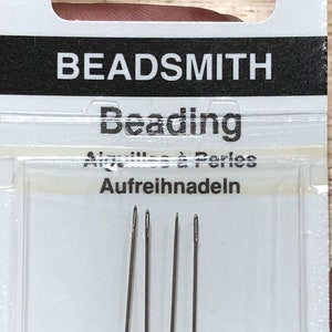 May include: Package of four size 10 beading needles, made in England. The package is yellow and white with the text "Beadsmith Beading" and "Finest Quality English Needles".