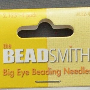 May include: A yellow and white package of The Beadsmith Big Eye Beading Needles. The package has a hang hole and says "2.125"-4 pack" and "#LLZ-4" on it.