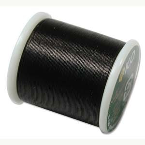 May include: A spool of black thread with white plastic sides. The thread is tightly wound, and the spool has a green and white label on one side. The thread appears to be for crafting or sewing.