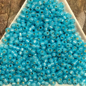 8-647, Miyuki 22g Silver Lined Aqua Alabaster 8-647, Miyuki 22g Silver Lined Aqua Alabaster