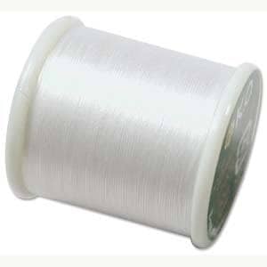 May include: A spool of white thread for sewing or embroidery.