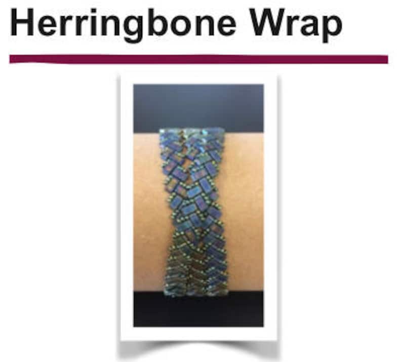 May include: A close-up of a blue and green herringbone bracelet made with small beads. The bracelet is on a person's wrist.