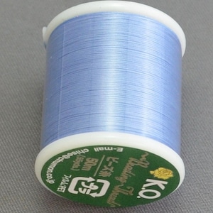 May include: A spool of light blue embroidery thread with a green label that reads "K.O. Braiding Thread ビーズ 50m (55ycles) フィルム:PET E-mail chise@chumon.co.jp".