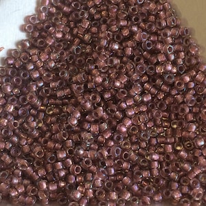 15/0 Japanese Seed Beads - Colorlined Metallic Rose AB Toho # 267 (aka 377G) (2&quot; round tube, approx 8.2 grams)