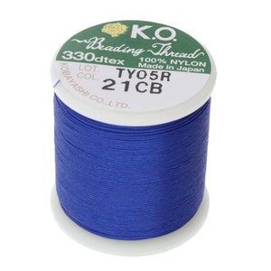 May include: A spool of blue nylon beading thread, labeled "K.O. Beading Thread 330dtex 100% Nylon Made in Japan LOT. COL. TYO5R 21CB KOBAYASHI CO.,LTD."
