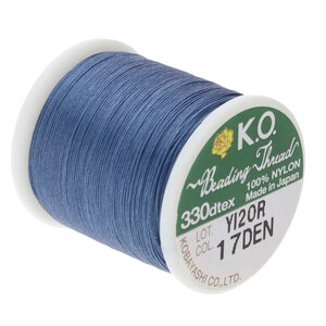 May include: A spool of blue nylon beading thread, labeled "K.O. Reading Thread 330dtex 100% NYLON Made in Japan LOT. YIZOR COL. 17DEN KOBAYASHI CO., LTD."