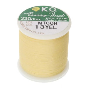 May include: A spool of yellow beading thread labeled "K.O. Beading Thread 330dtex 100% NYLON Made in Japan LOT. COL. MTOOR 13YEL KOBAYASHI CO.,LTD."